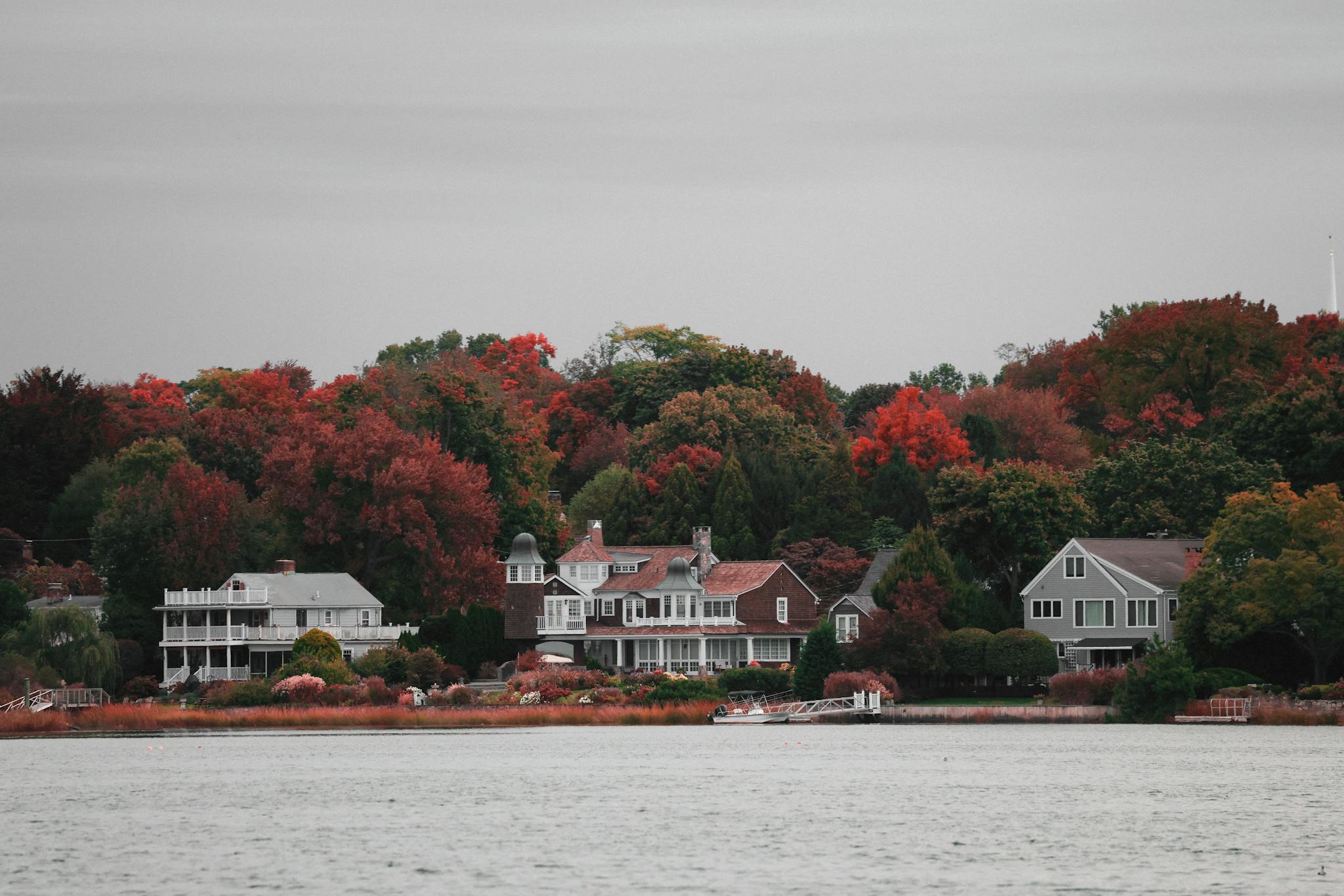 Charming waterfront homes nestled in vibrant autumn foliage in Stamford, Connecticut.